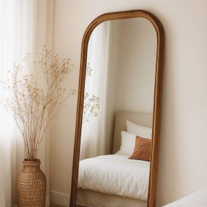 Arched full-length floor mirror with wooden frame in a calm modern room